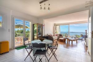 a living room with a table and chairs at 3 bedroom artist's house with AC, spectacular sea view - Dodo et Tartine in Toulon