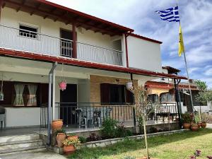a house with an american flag in front of it at Apartment Antigoni in Nea Kallikrateia