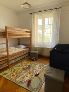 Zimmer mit 2 Etagenbetten und einem Teppich in der Unterkunft Chez Carole (4 pièces) in Neuenburg