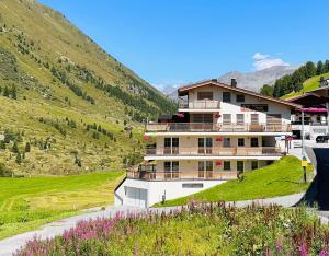 a large building on the side of a mountain at Appartements Andy in Obergurgl