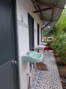a bathroom with a sink on the side of a building at BenTrestay in Giồng Tú Ðiền