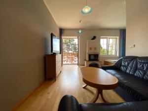 a living room with a couch and a table at apartmán Maják u Žermanické přehrady in Pitrov