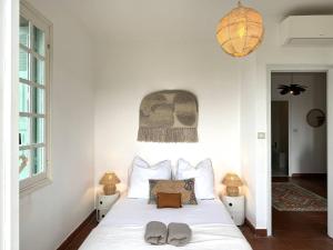 a bedroom with a bed with two slippers on it at VILLA A MUREDDA, piscine chauffée et vue mer in Olmeto