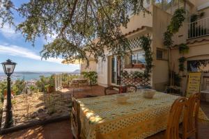 a table on a patio with a view of the ocean at 3 bedroom artist's house with AC, spectacular sea view - Dodo et Tartine in Toulon