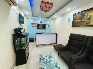 uma sala de espera com um sofá e um aquário em Hotel Imperial Inn - Nehru Enclave em Nova Deli