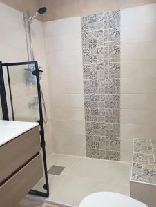 a bathroom with a shower with a glass door at Voula's maisonette in Acharavi +10 photos