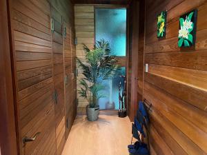 a hallway with wooden walls and a potted plant at Tabinoteitaku Zao Miyagi in Zao