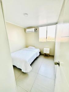 Ένα ή περισσότερα κρεβάτια σε δωμάτιο στο Cozy Peruvian Home