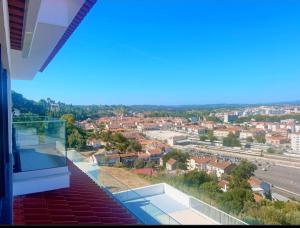 a view of a city from the balcony of a house at Vila Pombal Tomar - Luxury Apartment with private pool and Castle View in Tomar