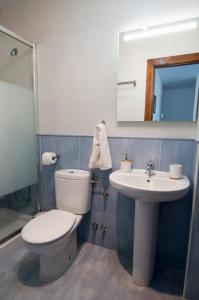 a bathroom with a toilet and a sink at La Casa de Maria in Santillana del Mar