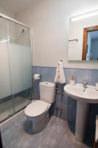 a bathroom with a toilet and a sink and a shower at La Casa de Maria in Santillana del Mar