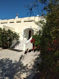 a white building with stairs and flowers in front of it at Peaceful oasis in Athens