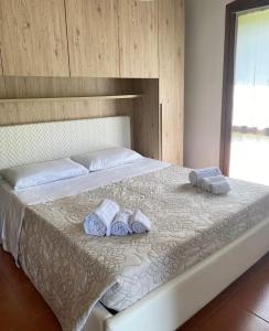 a bedroom with a bed with towels on it at Residenza Diana in Vicenza