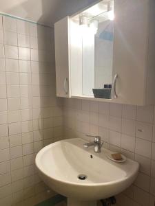 a bathroom with a white sink and a mirror at Residenza Diana in Vicenza