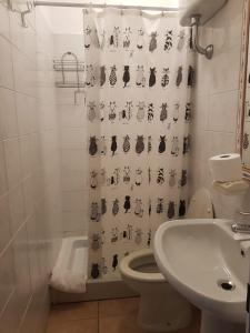 a bathroom with a shower curtain with a toilet and a sink at Sa Jaga Brujada Residence - Simar Vacanze in Porto Rotondo +55 photos