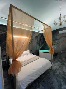 a bedroom with a bed with a canopy at Dimora 900 in San Severo