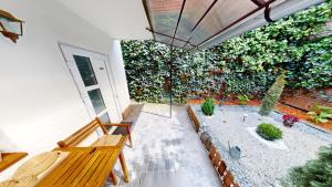 a living room with a large wall of plants at Tischler Studio VRT in Sibiu