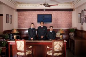 a group of three men sitting at a table at Yarlam Portico in Gangtok