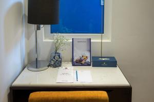 a table with a lamp and a book on it at Hanoi Brilliant Hotel & Spa in Hanoi +89 photos