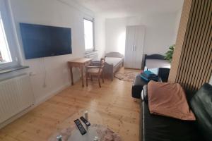 a living room with a couch and a table at Wohnen in Niederweimar zwischen Marburg und Gießen in Niederweimar