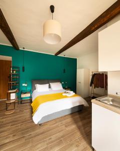 a bedroom with a bed and a green wall at All'Ombra della Torre in Viterbo