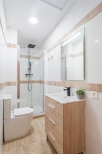a bathroom with a toilet and a sink and a shower at Sunny Modern Flat by Mercado Central in Valencia