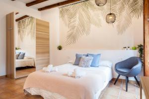 a bedroom with a bed and a chair and a mirror at Sunny Modern Flat by Mercado Central in Valencia