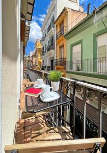 a balcony with a table with two coffee cups on it at Sunny Modern Flat by Mercado Central in Valencia