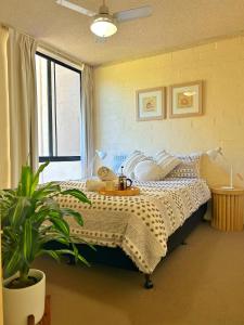 a bedroom with a bed and a potted plant at Riverview Holiday Apartment 92 - Kalbarri WA in Kalbarri