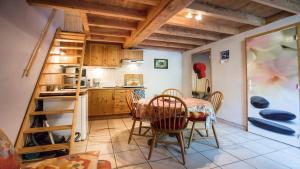 a kitchen and dining room with a table and chairs at Moulin de Record in Ferrières +74 photos