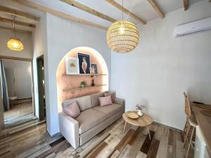 a living room with a couch and a table at Stone House Maria in Skala Marion