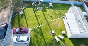 an aerial view of a park with cars parked in the grass at 3Priedes pie jūras in Šķēde