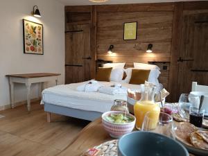 a bedroom with a bed and a table with food at La Tour du Laurensou in Figeac