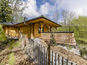 a wooden house with a fence in front of it at Ferienhaus BergesGlück in Eslohe