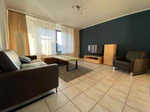 a living room with a couch and a television at Ferienwohnung Am Flörbach in Ahaus