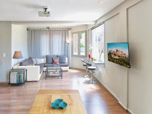 a living room with a couch and a table at Luxurious Top Floor Acropolis View Loft in Plaka - Newly Refurbished in Athens