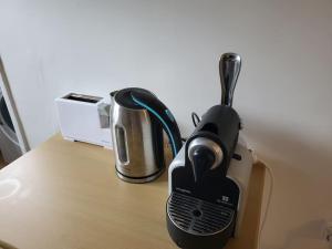 a coffee maker sitting on top of a table at Cosy Appartement Paris Ouest in Suresnes