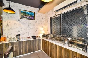 a restaurant kitchen with a bunch of pans on the wall at Pinaz Royale in Amritsar