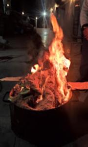 a large grill with fire in it on a street at Dhanolti Resort in Dhanaulti