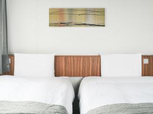 Postel nebo postele na pokoji v ubytování VESSEL INN NAMBA