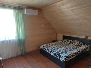 a bedroom with a bed in a room with a window at Садиба Миколайовича in Skole