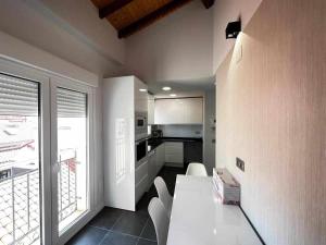 a kitchen with a white table and white chairs at Mati's Suite - San Torcuato 4 in Zamora