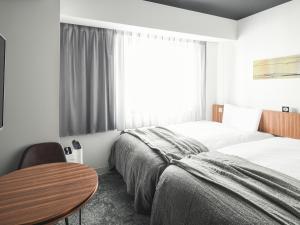 Postel nebo postele na pokoji v ubytování VESSEL INN NAMBA