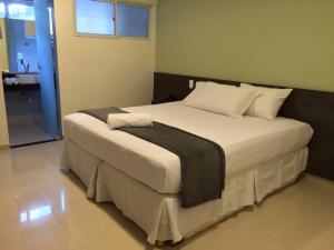 A bed or beds in a room at Scenarium Hotel