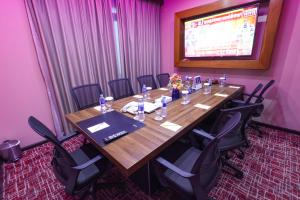 a conference room with a long wooden table and chairs at Fortune Grand Hotel in Dubai