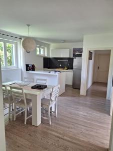 a kitchen and dining room with a table and chairs at Sailing Forever Bungalow in Kaštela +27 photos