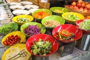 a buffet filled with bowls of different types of food at InterContinental Sanya Resort, an IHG Hotel in Sanya