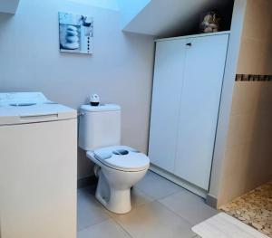 a bathroom with a white toilet and a sink at Cap sur l'océan in Saint-Brevin-les-Pins +31 photos