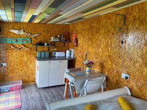a kitchen with a table and a small kitchen with a counter at Sunrise Cabin in Carbis Bay