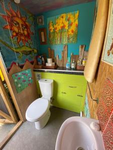 a bathroom with a white toilet and a sink at Sunrise Cabin in Carbis Bay +32 photos